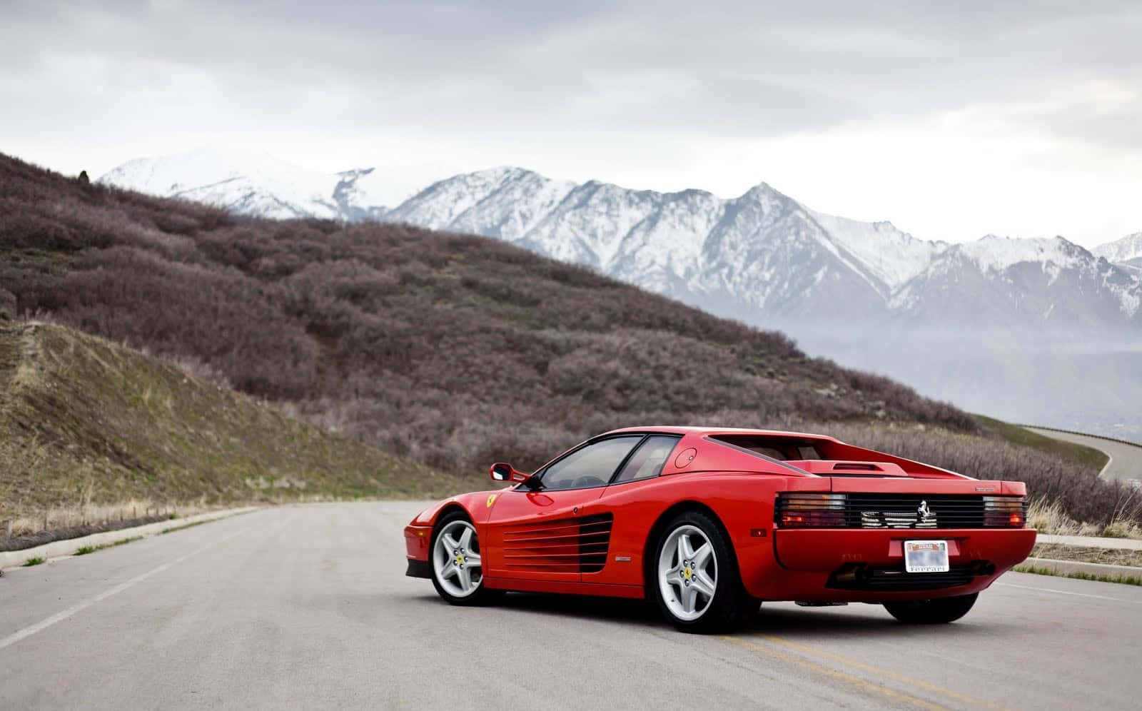 Sleek Red Ferrari Testarossa On The Road Wallpaper