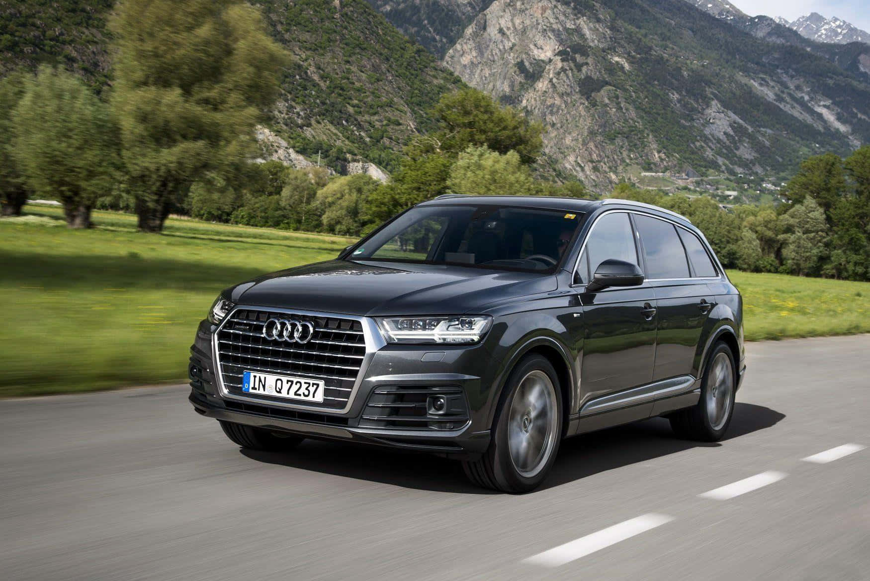 Sleek Silver Audi Q7 On The Open Road Wallpaper