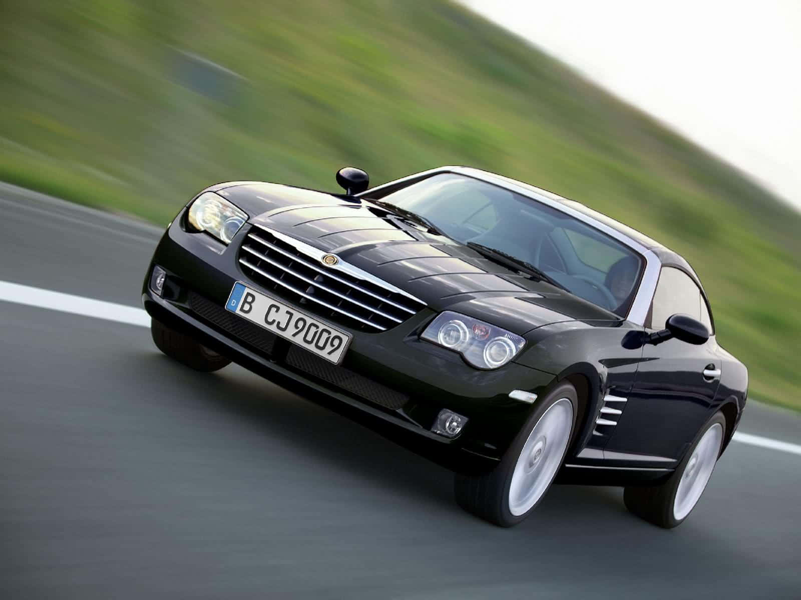 Sleek Silver Chrysler Crossfire On The Road Wallpaper