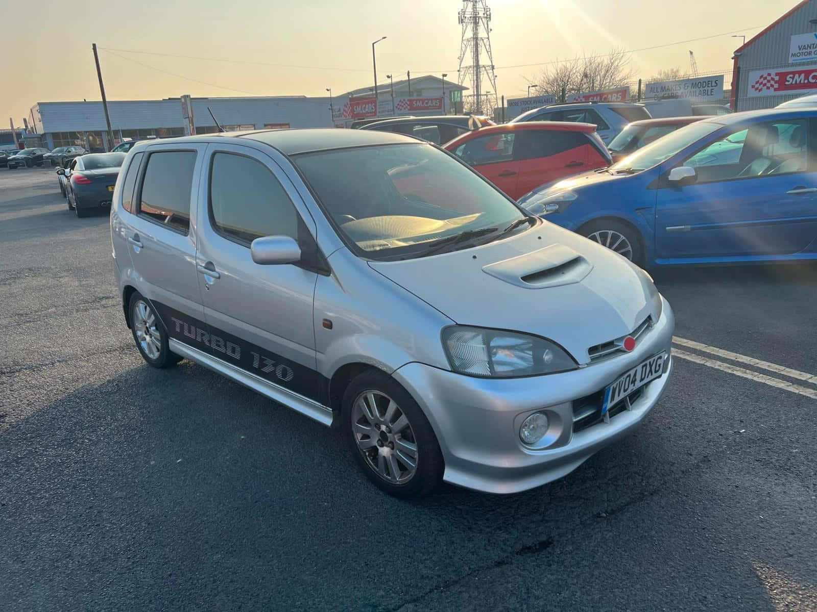 Sleek Silver Daihatsu Yrv During Sunset Wallpaper