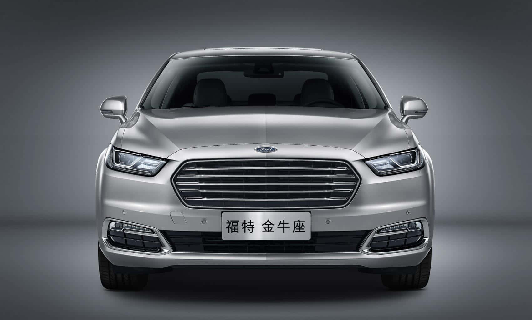 Sleek Silver Ford Taurus On The Road Wallpaper