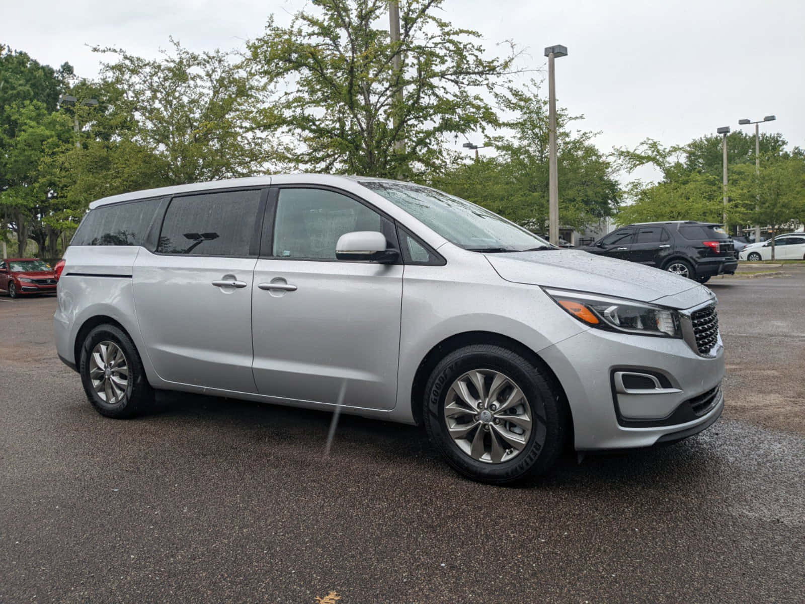 Sleek Silver Kia Sedona Minivan Cruising On The Open Road Wallpaper