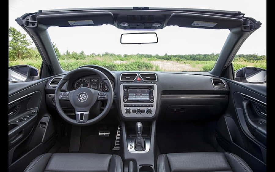 Sleek Silver Volkswagen Eos Parked On A Paved Road Wallpaper