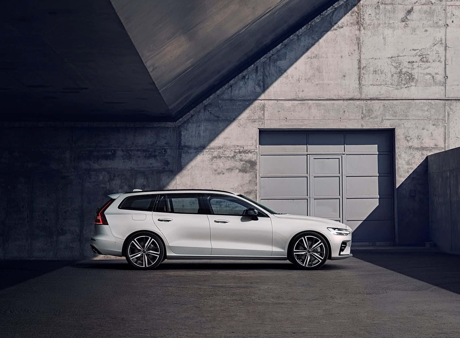 Sleek Volvo V60 In Night Cityscape Wallpaper