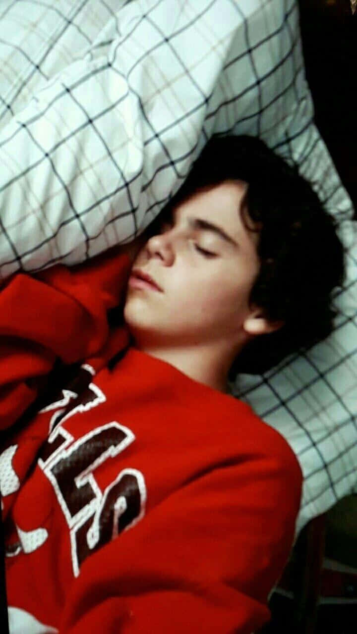 Sleeping Teenin Red Sweater Wallpaper