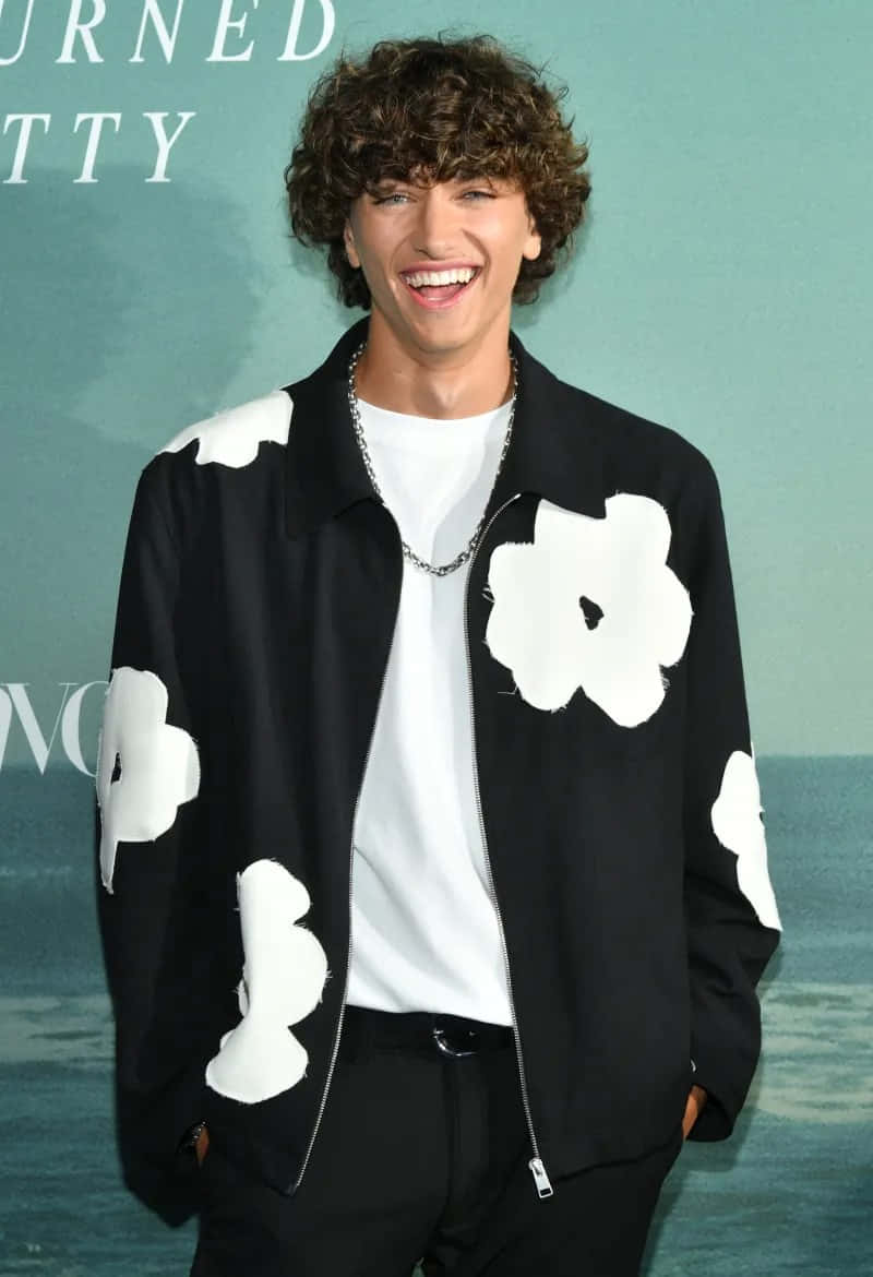 Smiling Man Floral Jacket Event Wallpaper