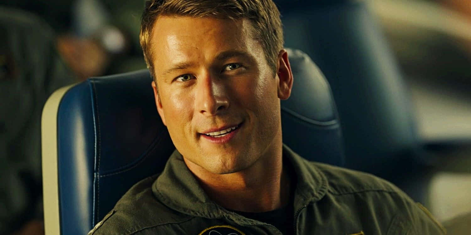 Smiling Pilot Glen Powell Wallpaper