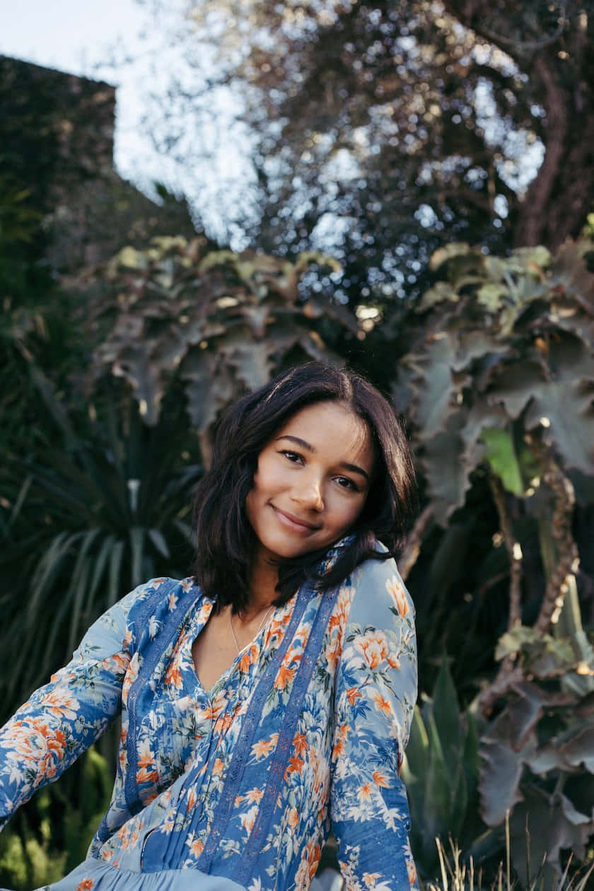 Smiling Woman Floral Dress Outdoors Wallpaper