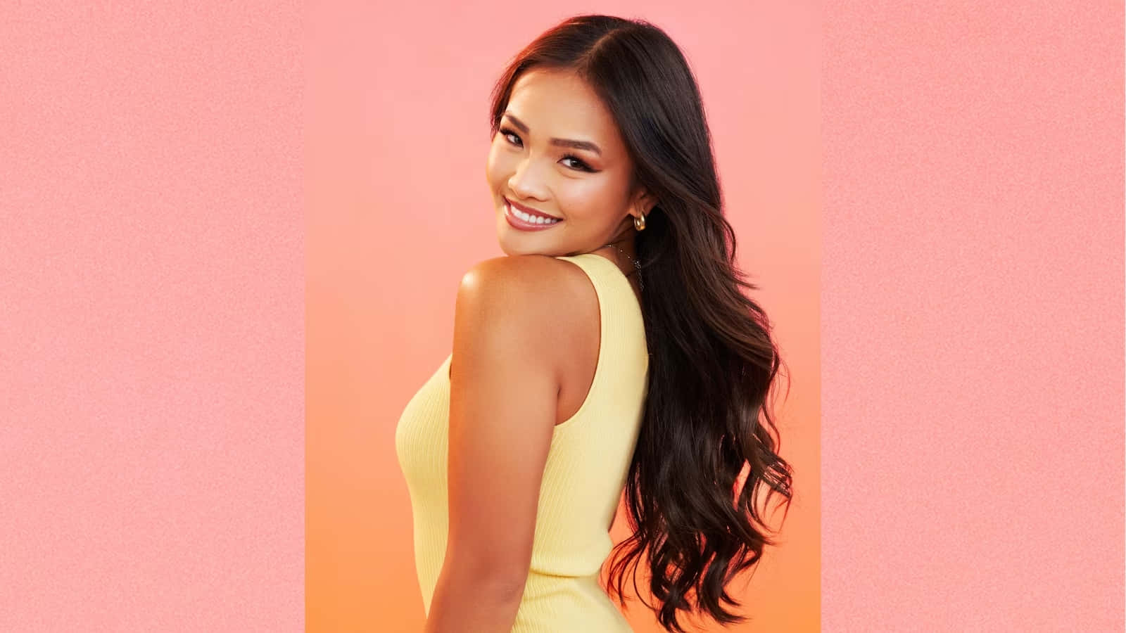 Smiling Woman Yellow Dress Pink Background Wallpaper