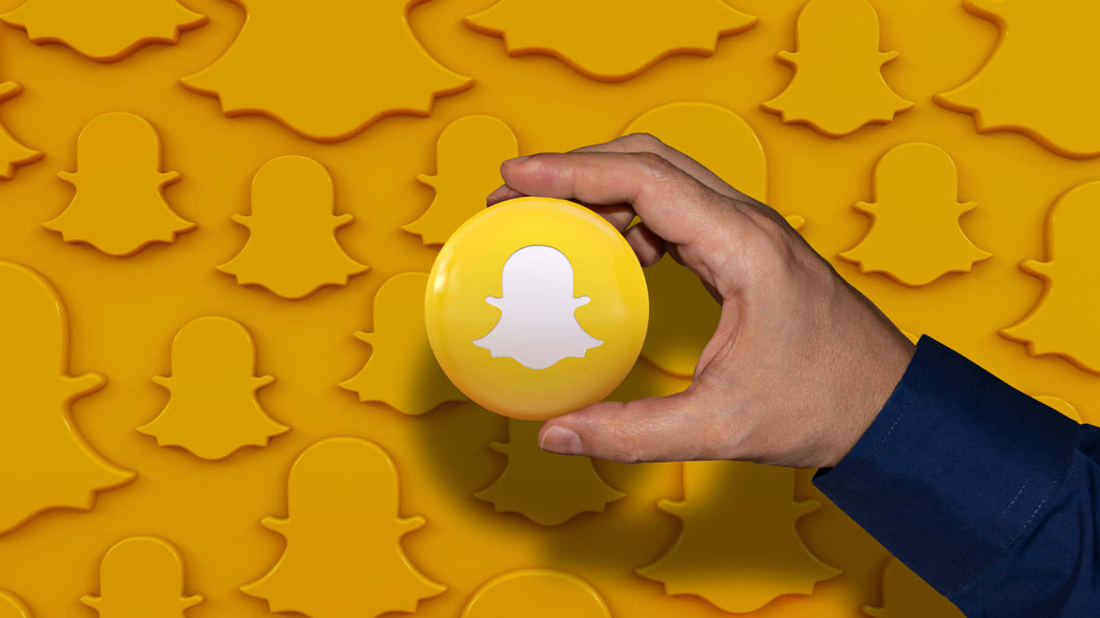 Snapchat_ Logo_ Held_ Against_ Ghost_ Background Wallpaper