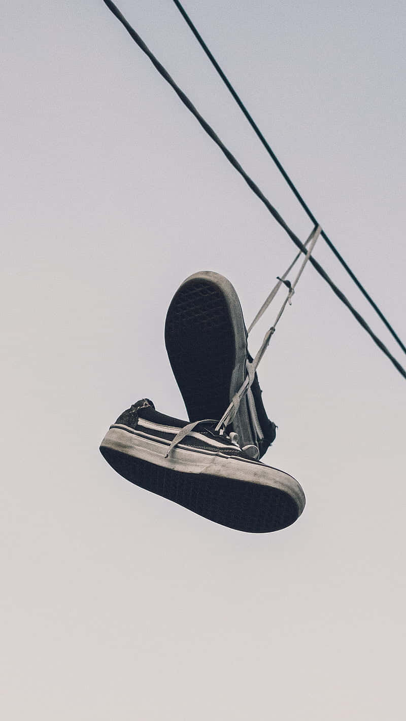 Sneakers Dangling From Powerline Wallpaper