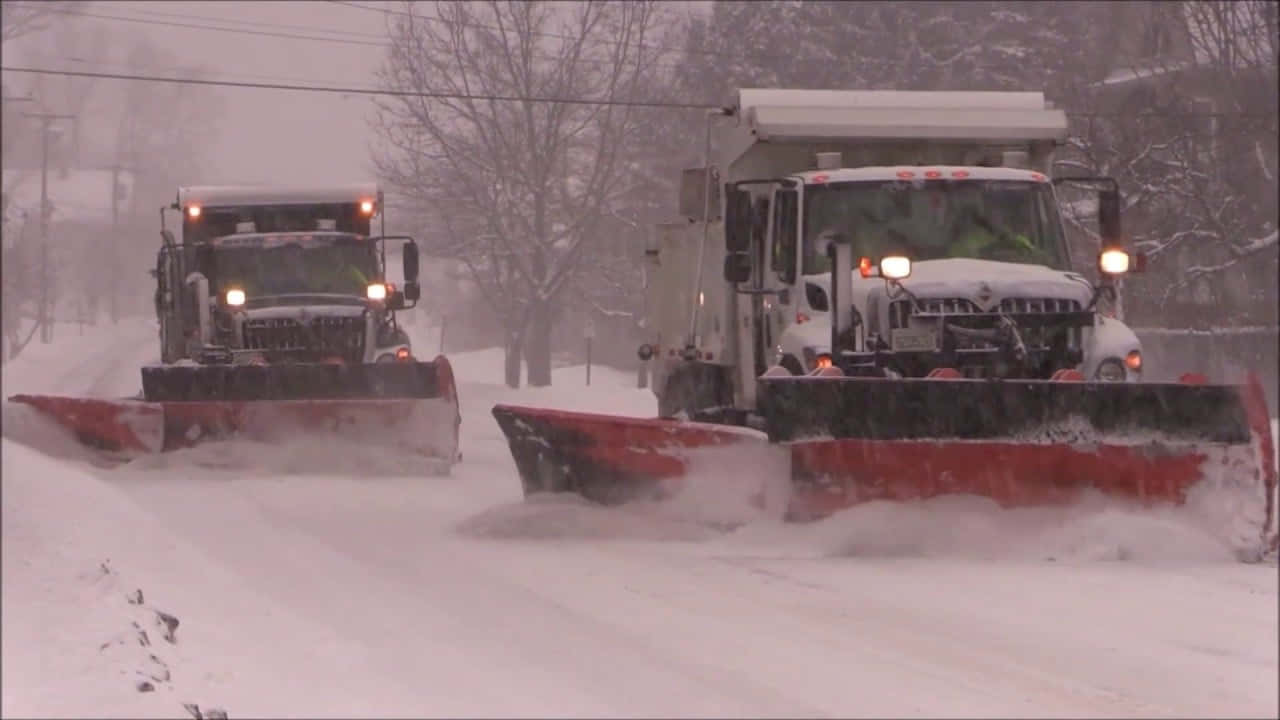 Snowplow Clearing The Snowy Road Wallpaper