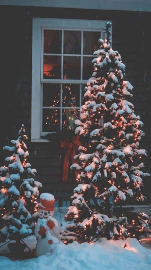 Snowy Christmas Treeand Snowman Outside Window Wallpaper