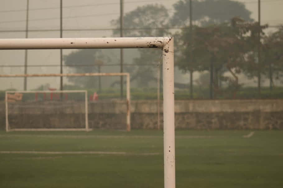 Soccer Goal Postsin Hazy Field Wallpaper