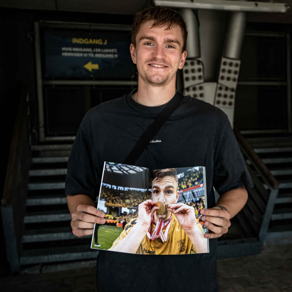 Soccer Player Holding Photo Wallpaper