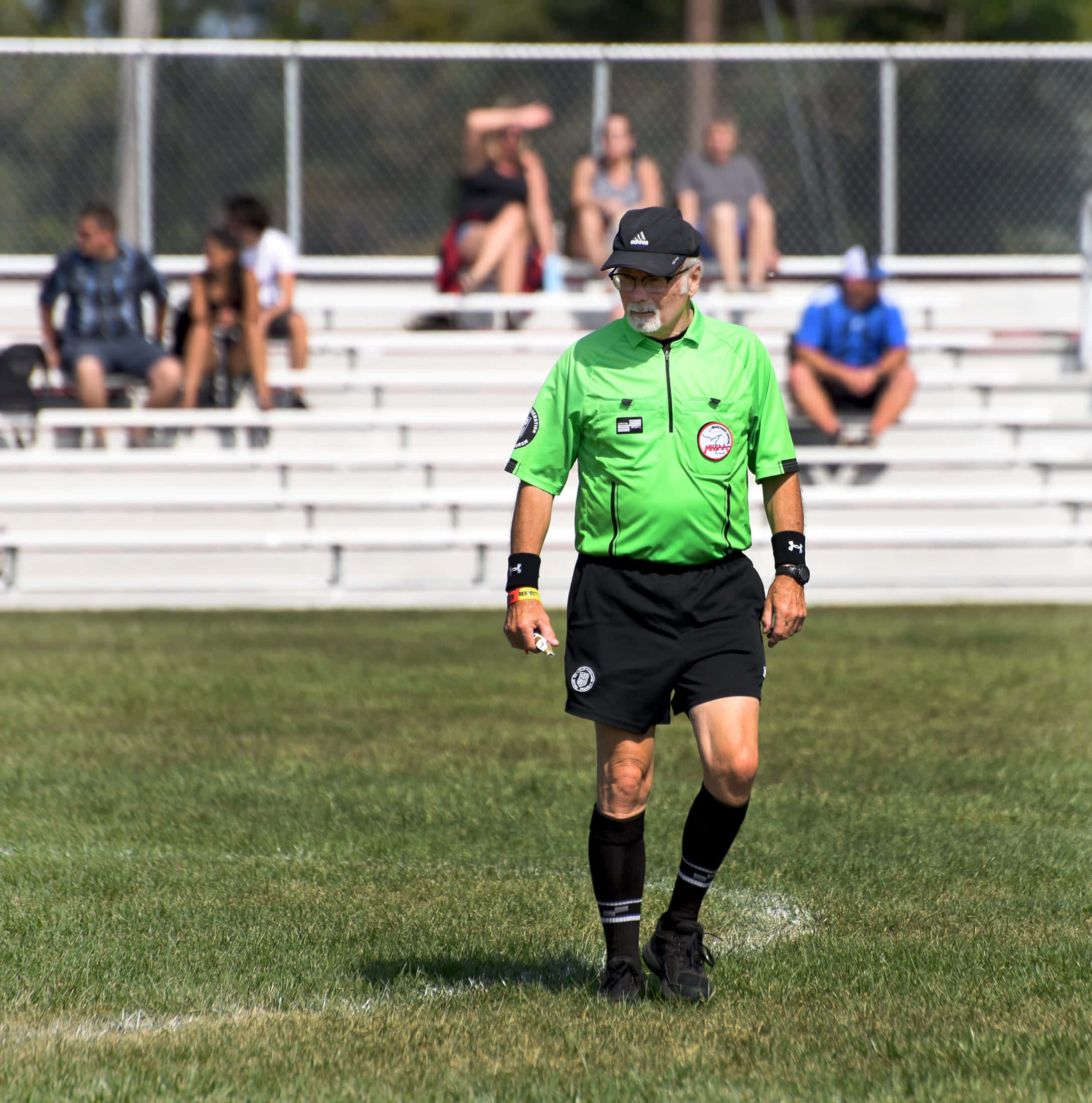 Soccer Referee Directing On Field Wallpaper