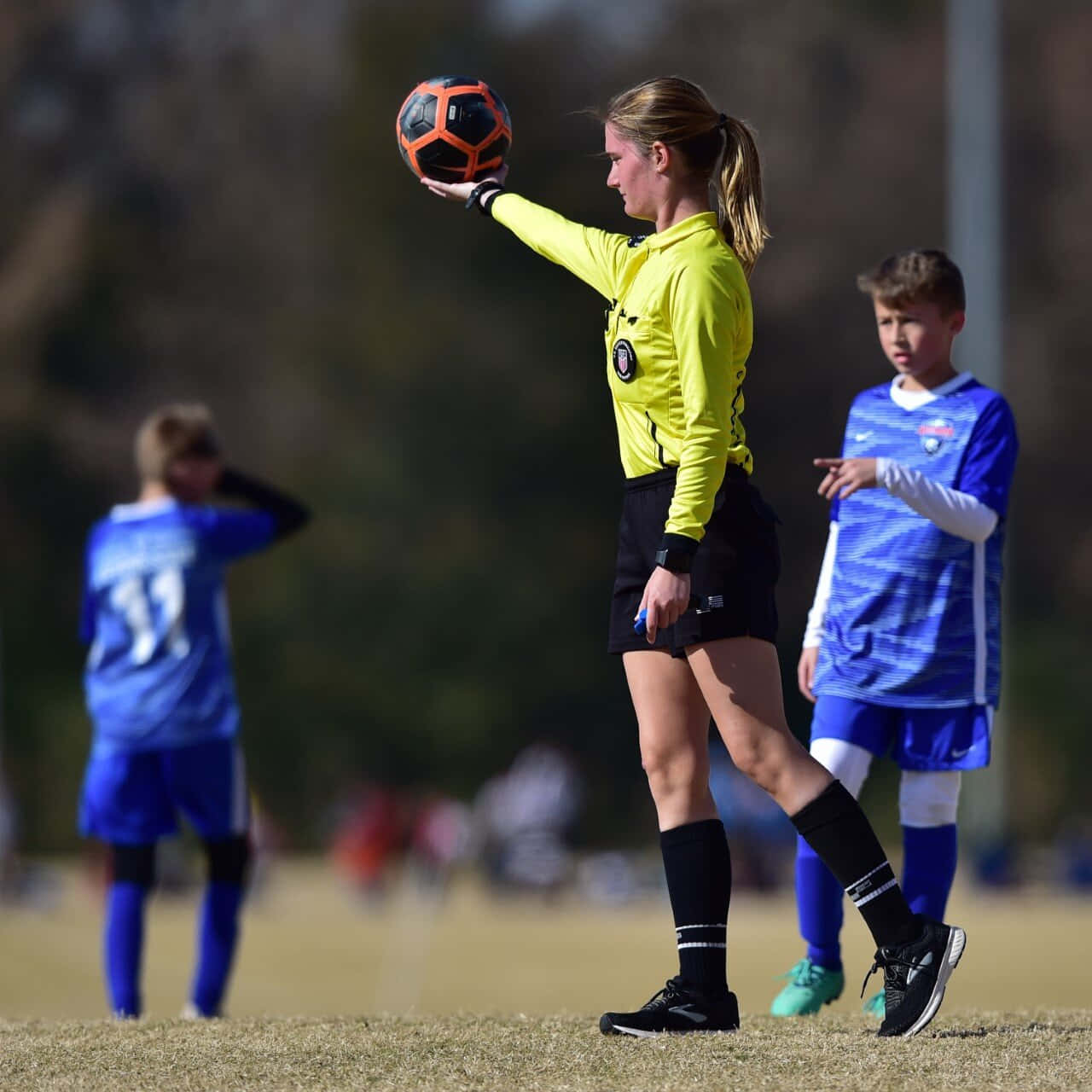 Soccer Referee Holding Ball During Match.jpg Wallpaper