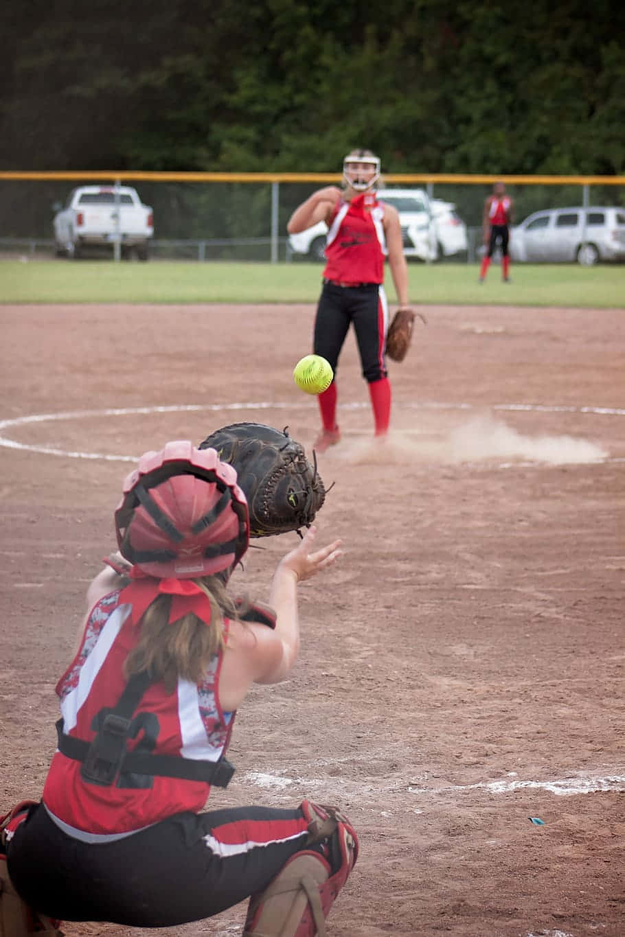 Softball Pitcherand Catcherin Action Wallpaper