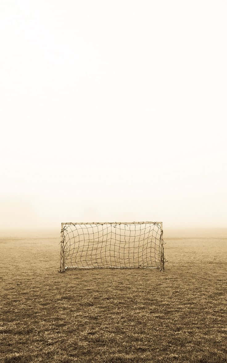 Solitary_ Soccer_ Goal_ In_ Fog Wallpaper