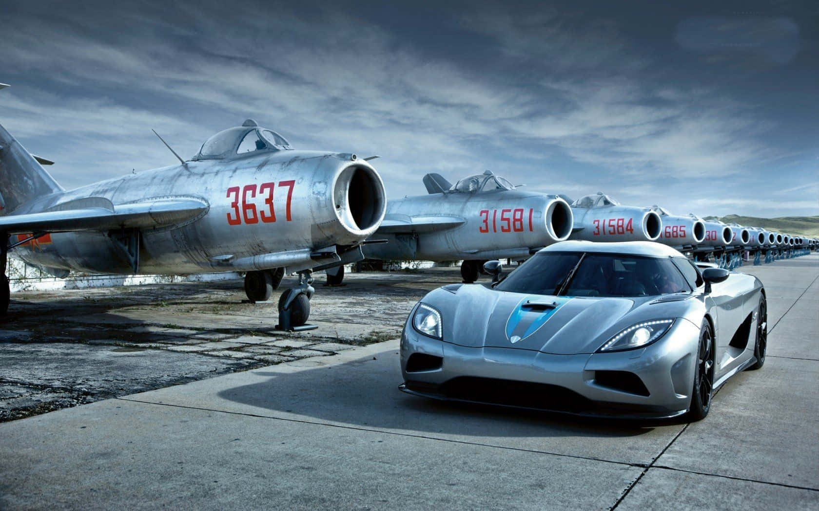 Speed Through The Skies And Roads With Jet And Car Wallpaper