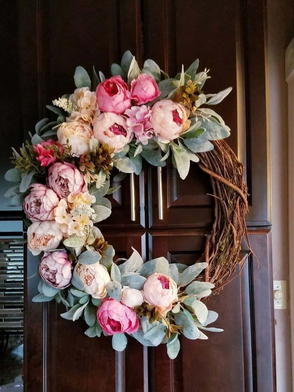 Spring Wreath With Vibrant Flowers And Fresh Green Leaves Wallpaper