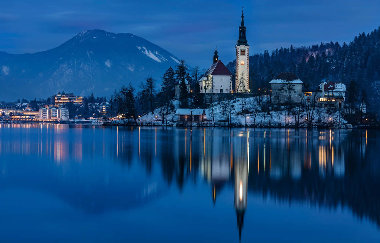 St. Martin Parish Beside Lake Bled At Night Wallpaper