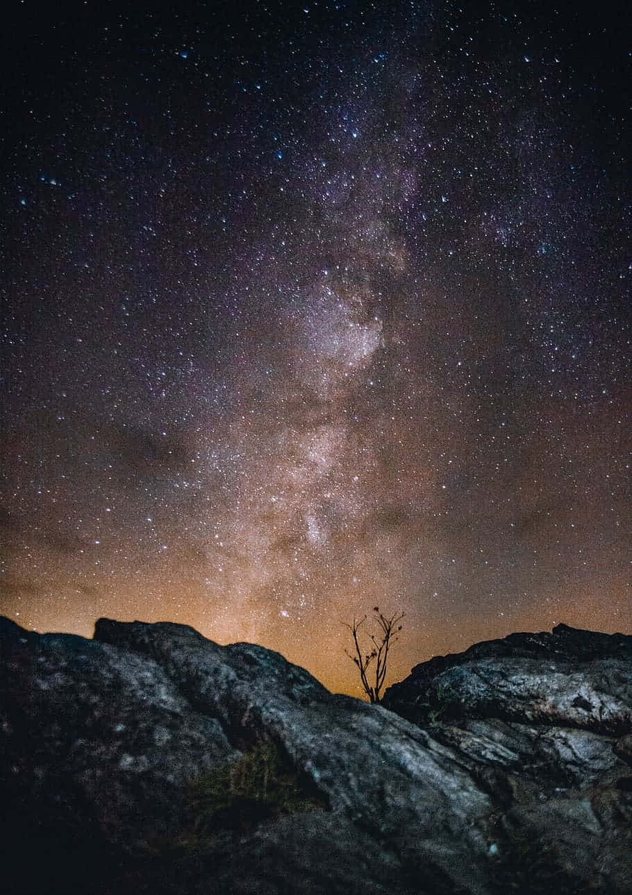 Starry Night Sky Over Rocks.jpg Wallpaper