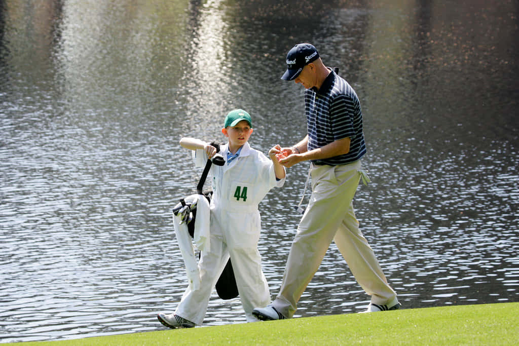 Steve Flesch Guiding A Young Golfer Wallpaper