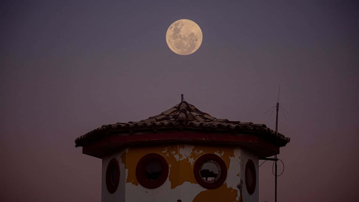 Strawberry Moon Over Traditional Building Wallpaper