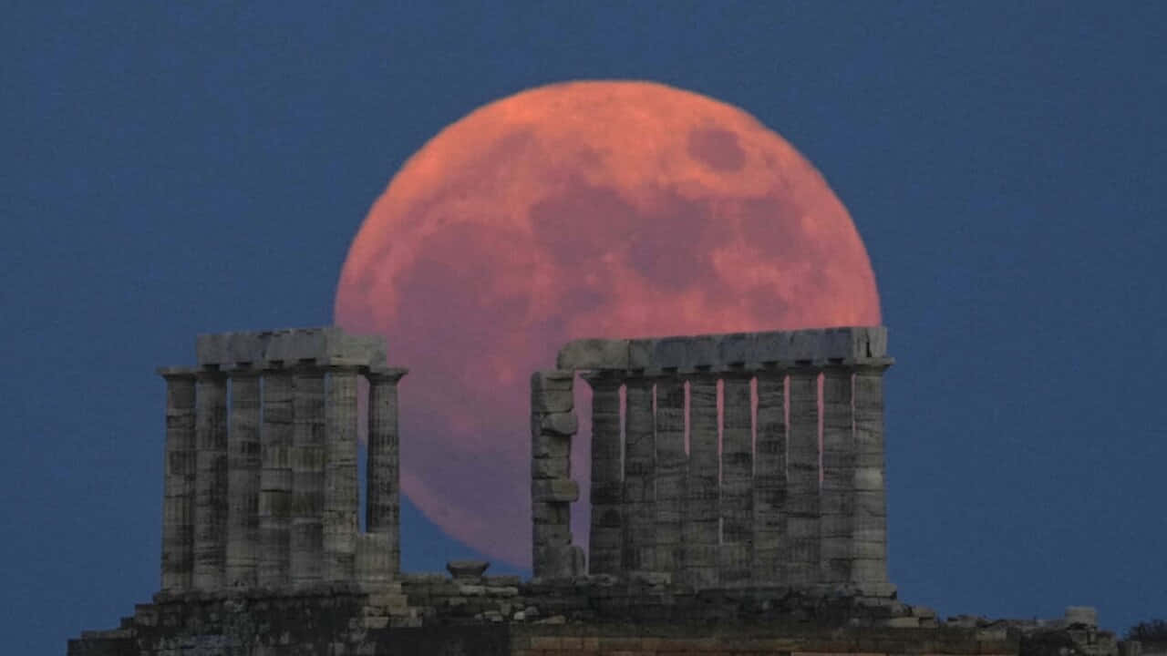 Strawberry Moon Rising Behind Ancient Columns Wallpaper