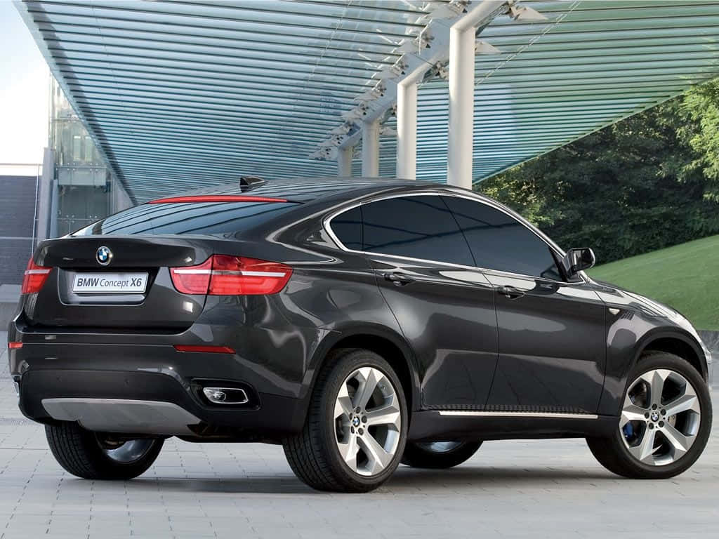 Striking Bmw X6 On Scenic Road Wallpaper