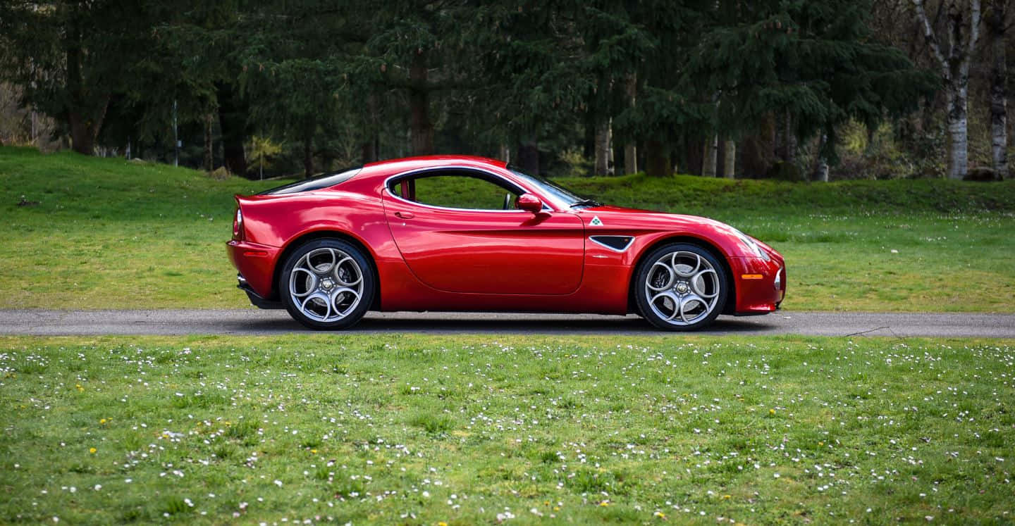 Striking Red Alfa Romeo 8c Competizione In Motion Wallpaper