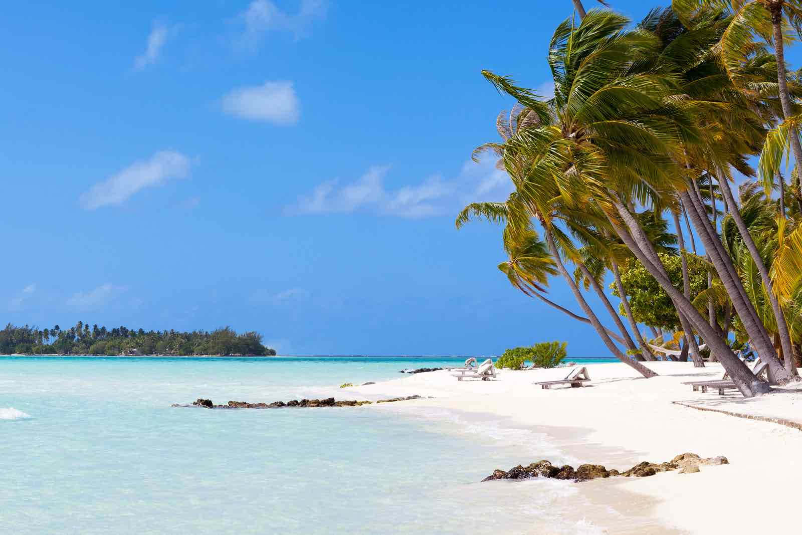 Stunning Bora Bora Beach With Overwater Bungalows And Lush Green Scenery. Wallpaper