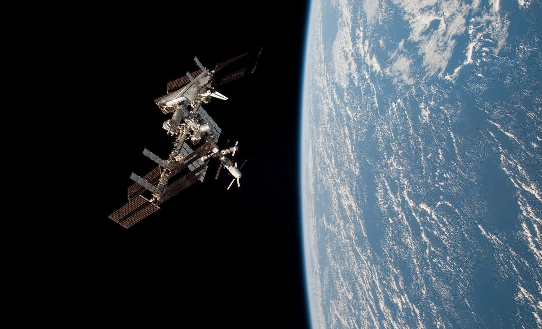 Stunning High-resolution View Of The International Space Station Orbiting Earth Wallpaper