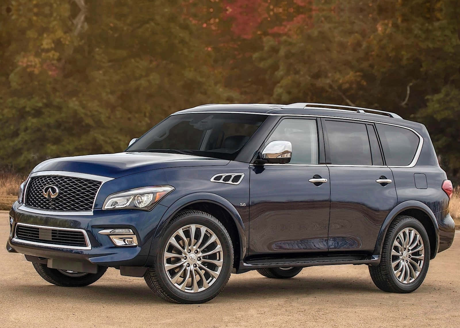 Stunning Infiniti Qx80 Showcased Against A Scenic Backdrop Wallpaper