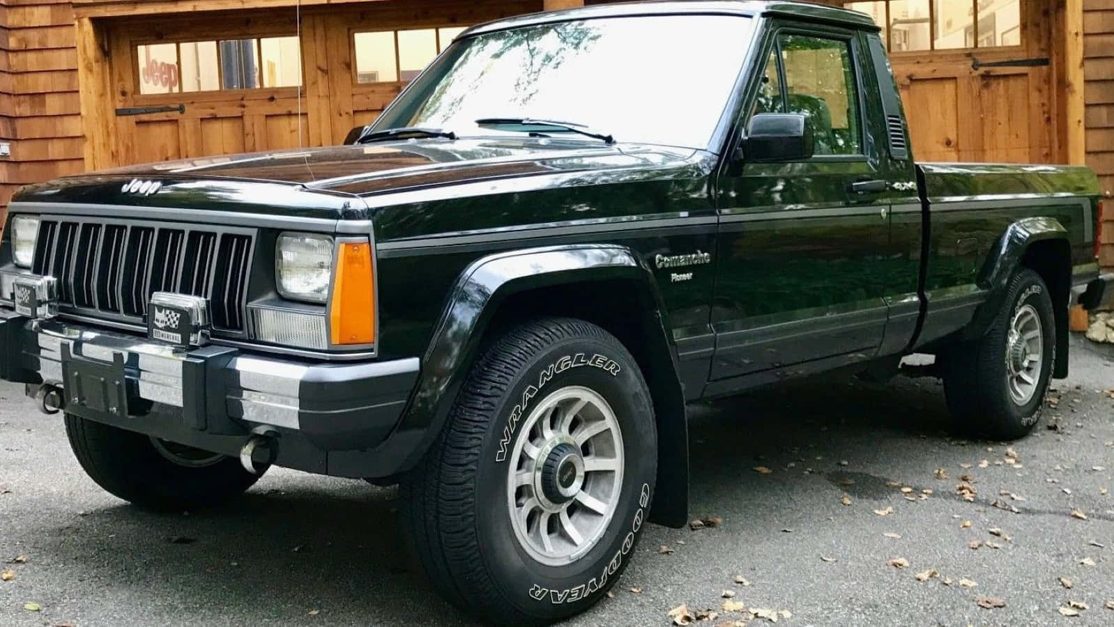 Stunning Jeep Comanche On A Scenic Trail Wallpaper