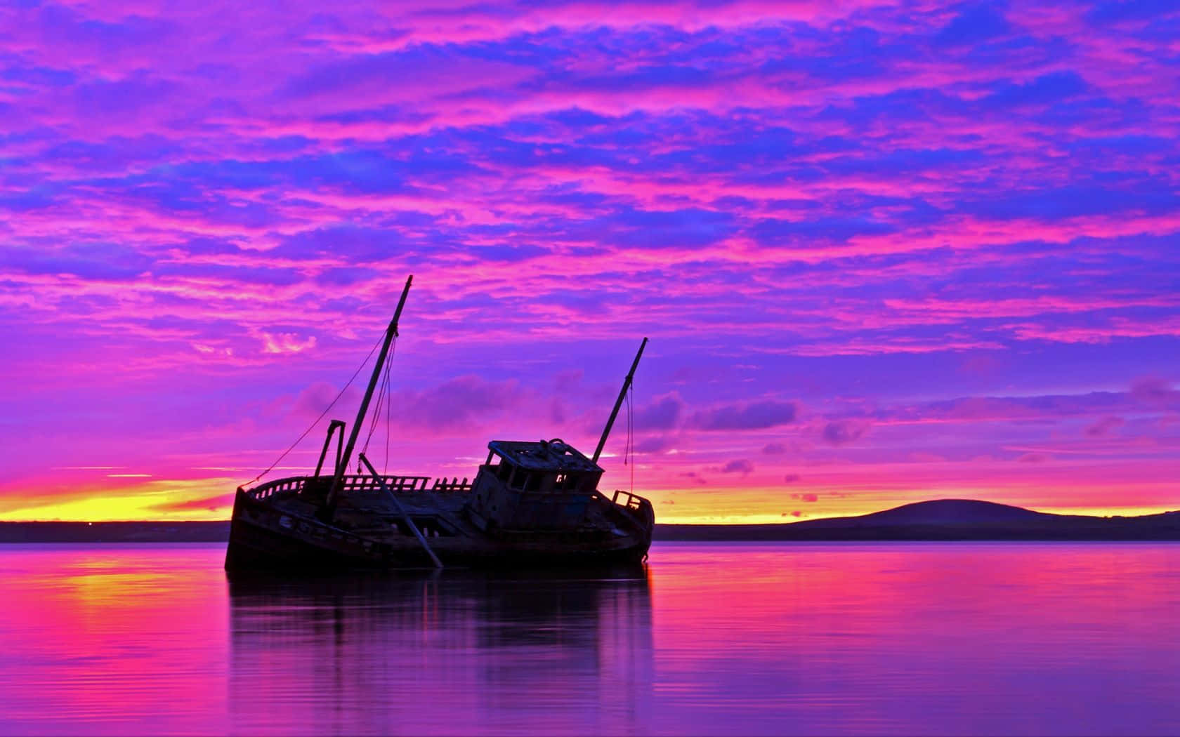 Stunning Purple Sunset Over The Ocean Wallpaper