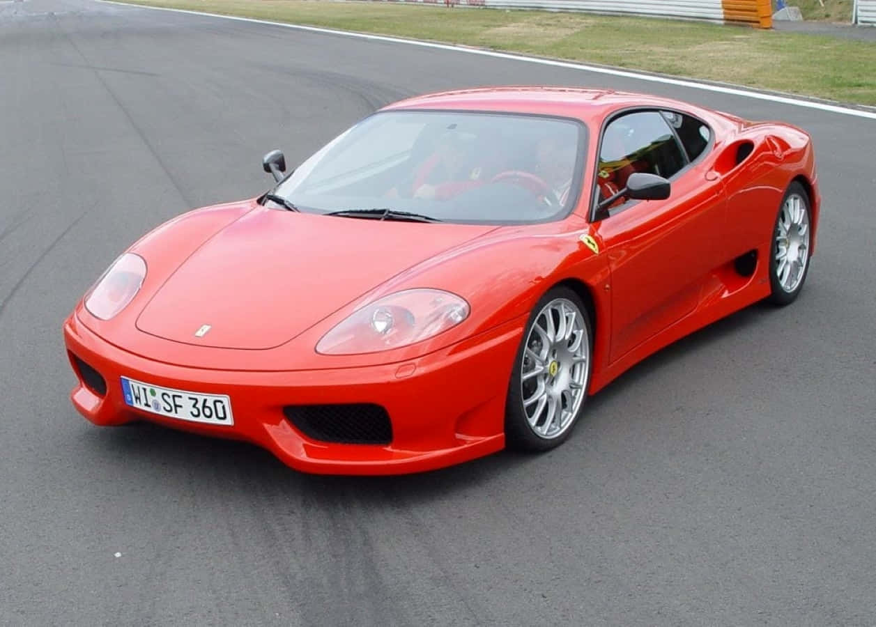 Stunning Red Ferrari 360 Modena Parked Outdoors Wallpaper