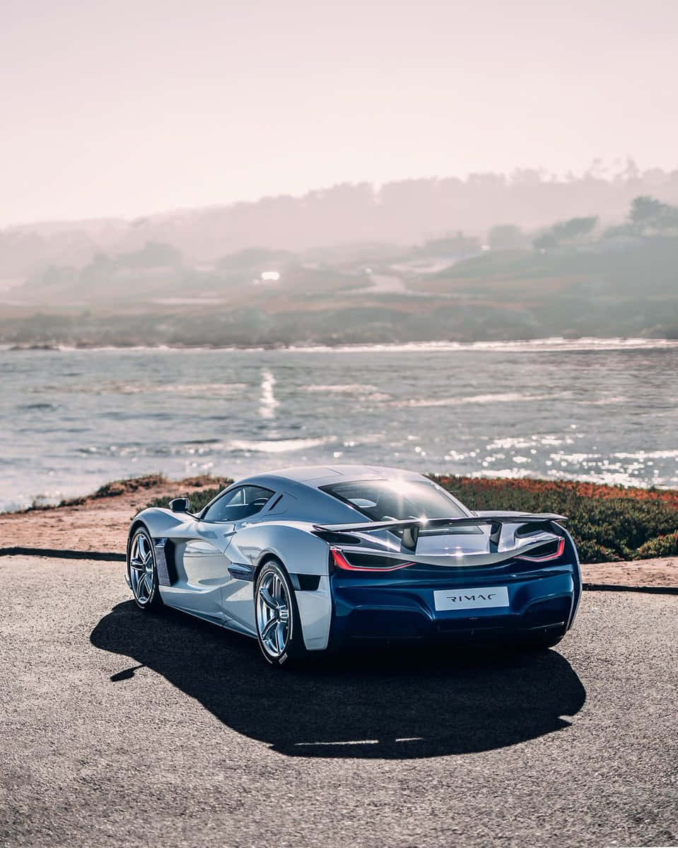 Stunning Rimac Nevera Accelerating On A Picturesque Route Wallpaper