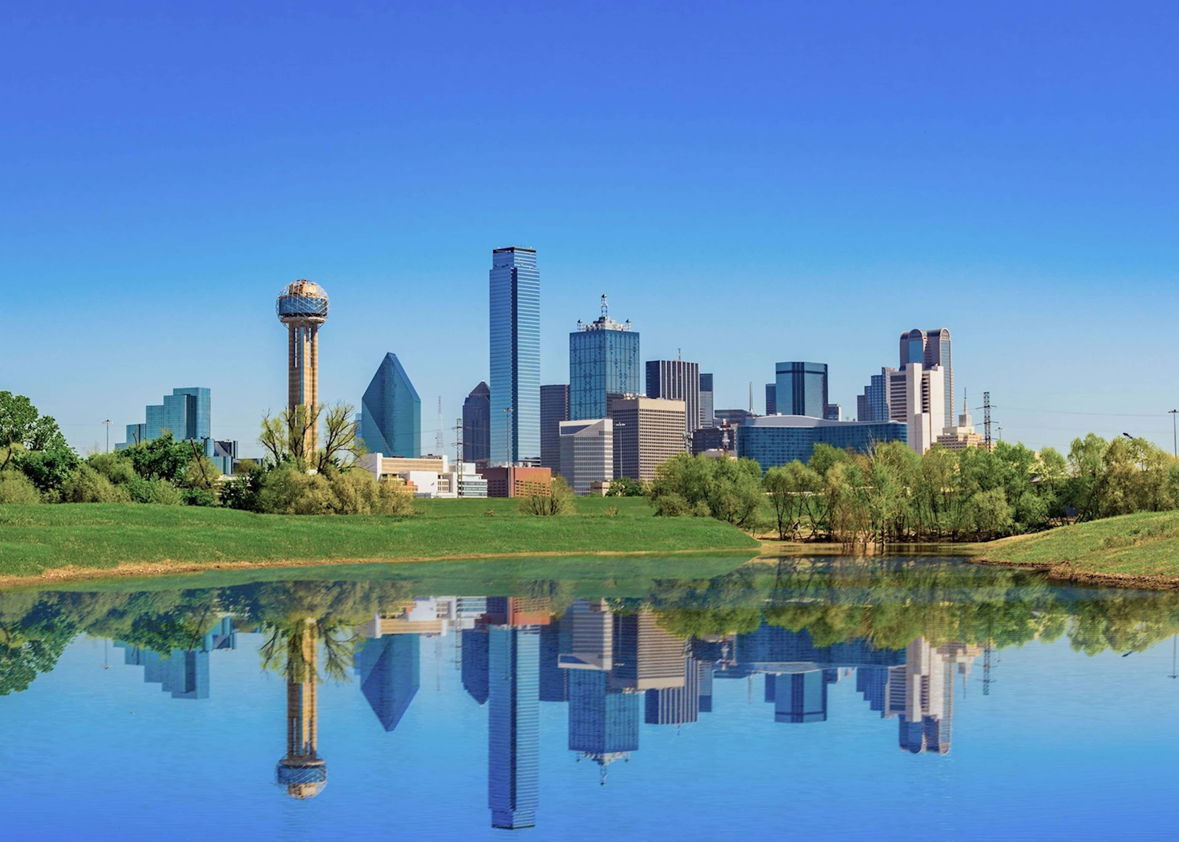 Stunning View Of Dallas Illuminated Skyline At Night Wallpaper