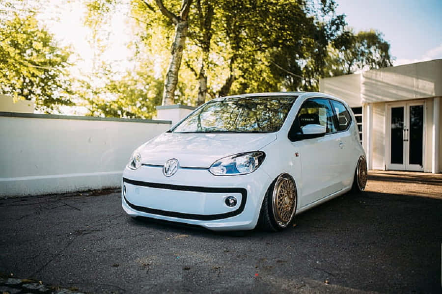 Stylish And Compact Volkswagen Up In Urban Landscape Wallpaper