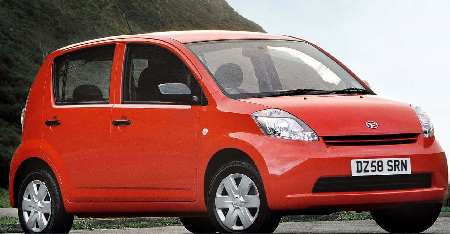 Stylish Daihatsu Sirion Cruising On The Highway Wallpaper