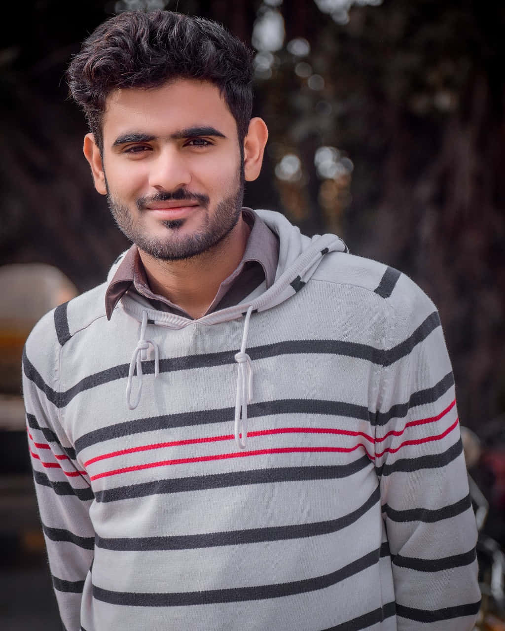 Stylish Indian Man Posing In A Bokeh Background Wallpaper