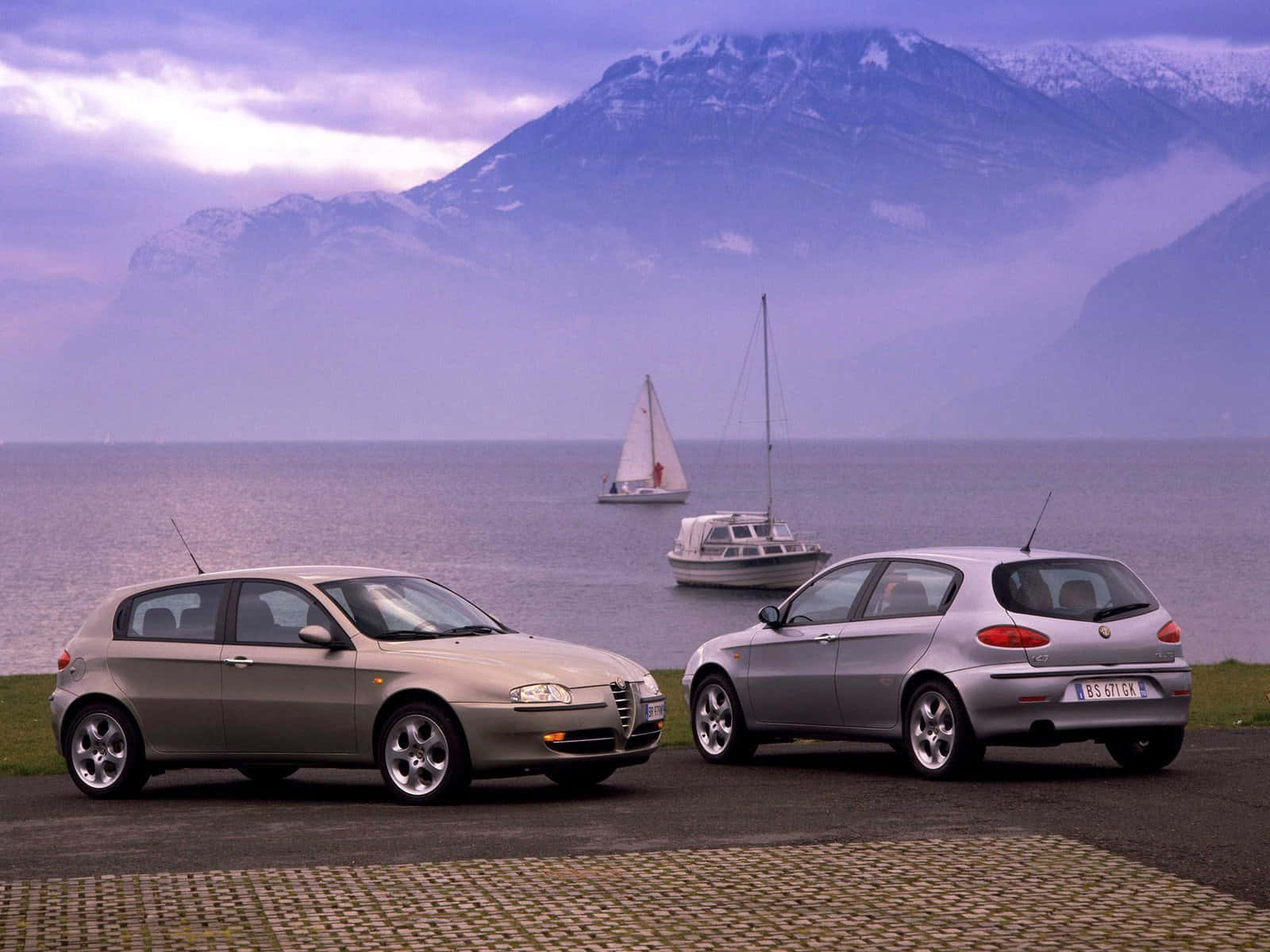 Stylish Red Alfa Romeo 147 On The Road Wallpaper