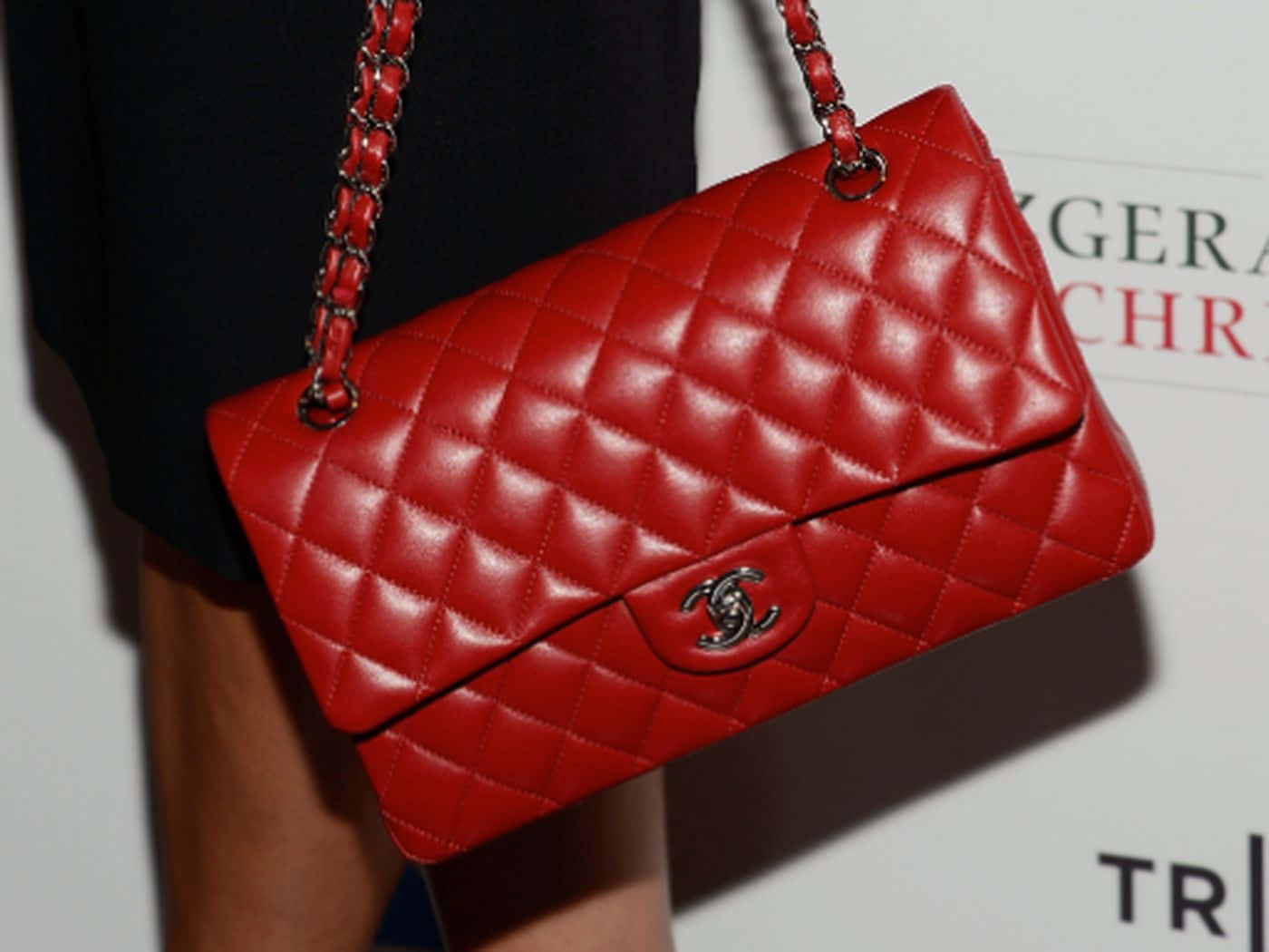 Stylish Red Handbag On A Wooden Table Wallpaper