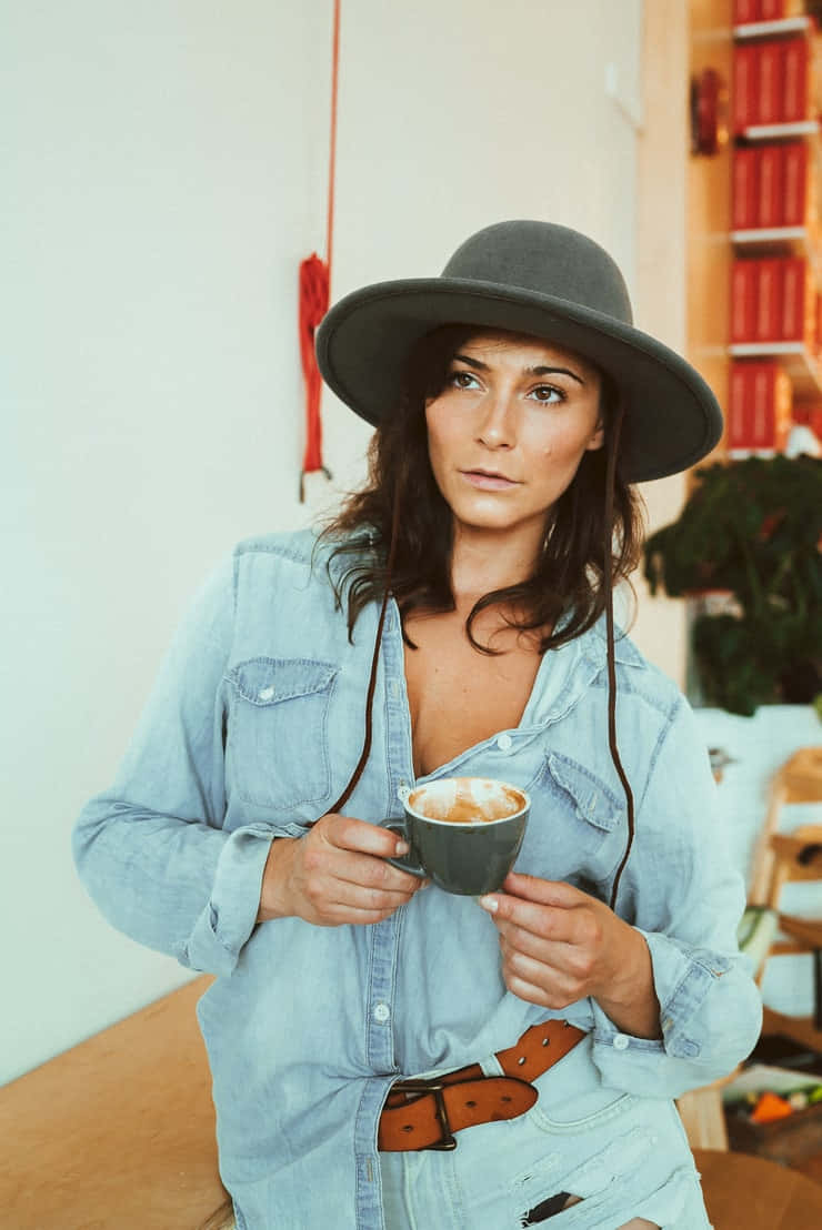 Stylish Womanin Hat Holding Coffee Cup Wallpaper