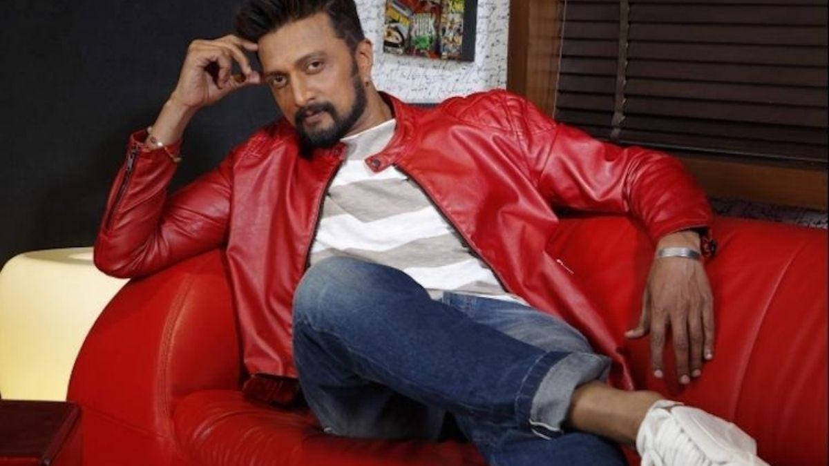 Sudeep On Plush Red Chair Wallpaper