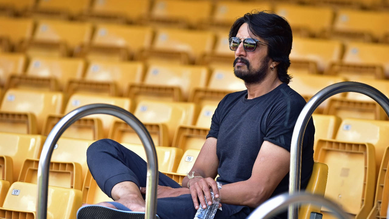 Sudeep Sitting On Bench Alone Wallpaper