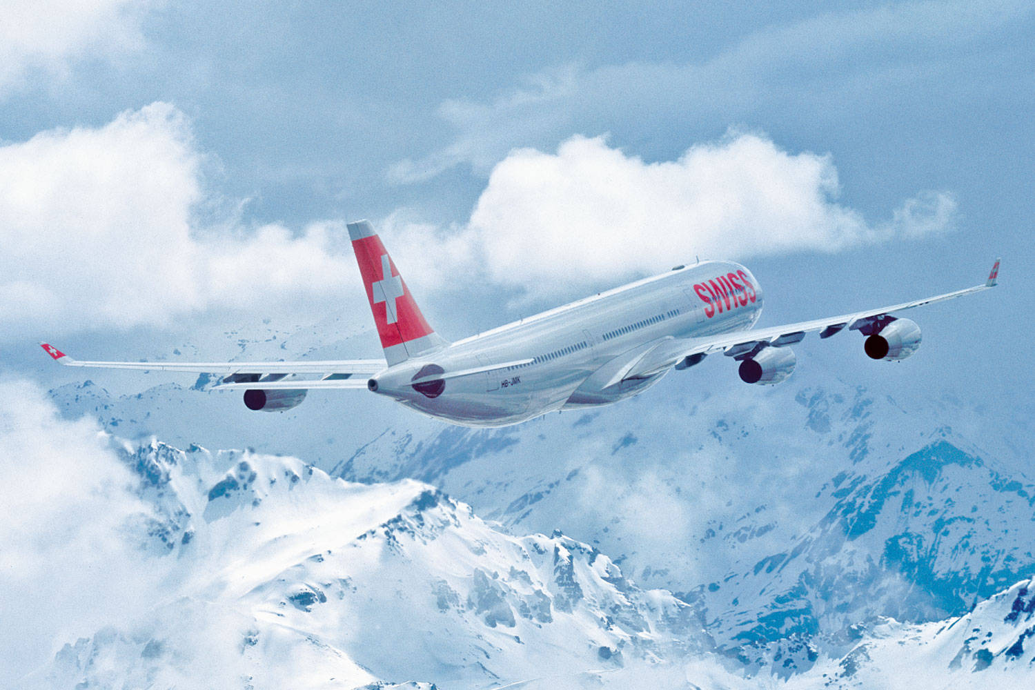 Swiss Airlines Airplane On A Cloudy Mountain Wallpaper