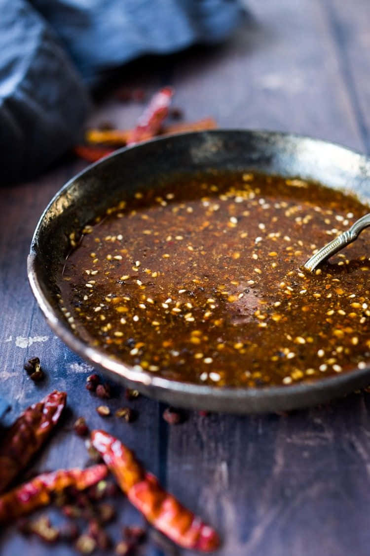 Szechuan Sauce In A Bowl Surrounded By Ingredients Wallpaper